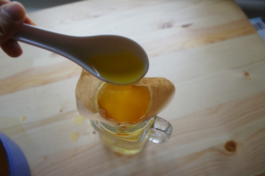 Step 6: Strain the milk solids out of the ghee