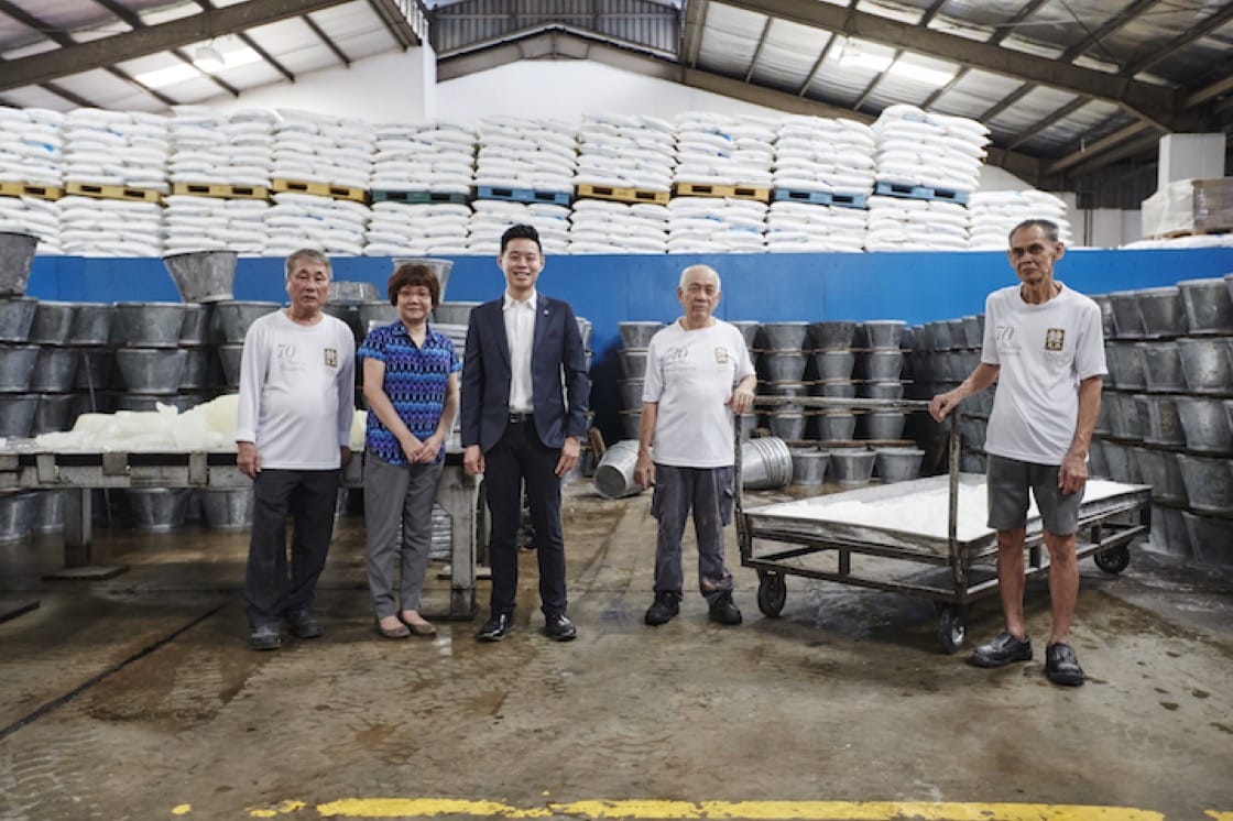 Third-gen business owner John Cheng (centre) with old-time employees of the sugar factory