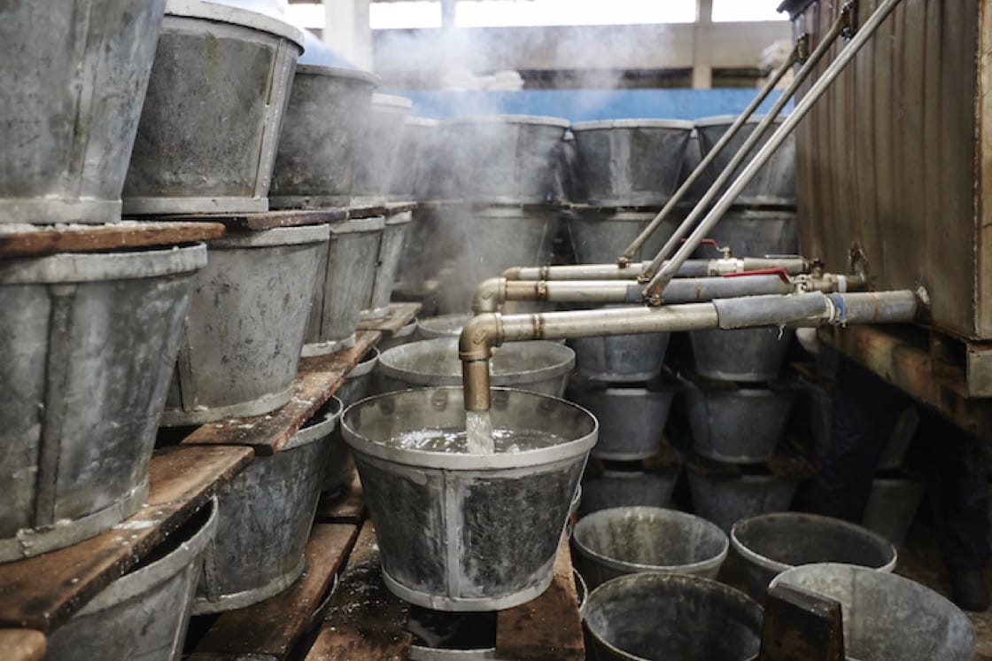 Iron buckets are filled with boiled down sugar syrup
