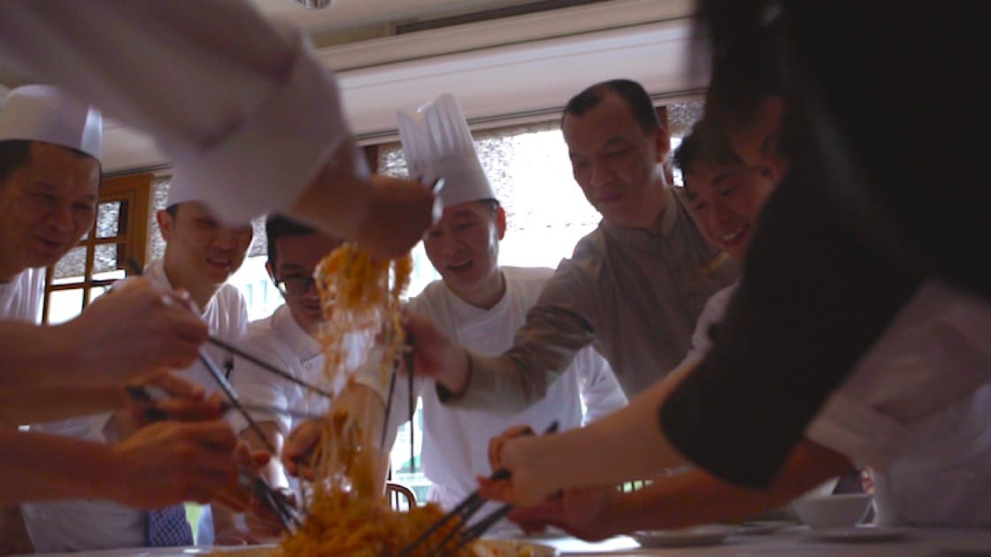 Chef Liu Ching Hai (middle) and his staff make it a point to have a lo hei before they commence dinner service on Chinese New Year's Eve. Photo: Han Pin 