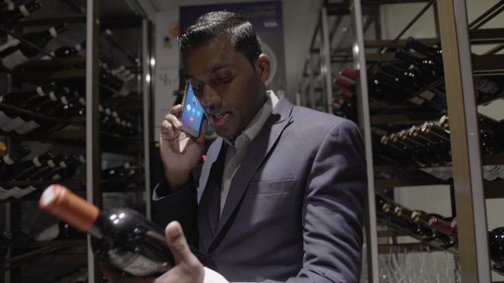 Alma's restaurant manager and sommelier Saravana explains wine notes to a customer over the phone