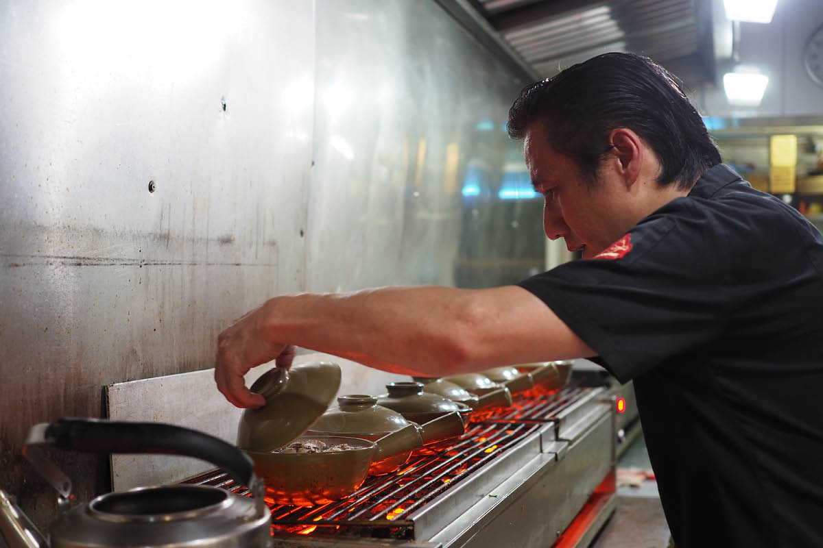 Lam (pictured above) says one must focus when cooking claypot rice to keep track of the doneness of each serving.