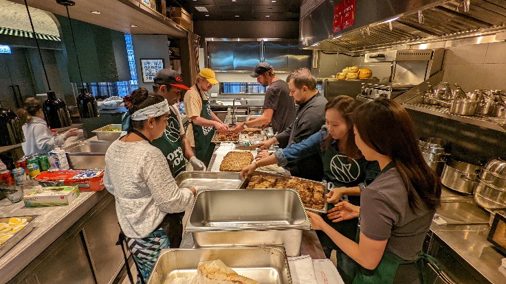 Chef Agustin Balbi (third from right) preparing meal boxes with MORE GOOD volunteers in the kitchen of Ando