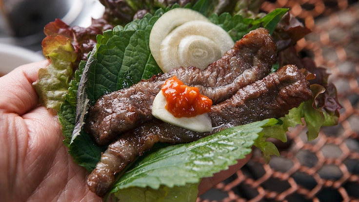 At Han's more casual Korean grill restaurant, expert chefs from NAE:UM grill meat in an open kitchen, creating a playful, informal ambiance that blends traditional Korean barbecue flavours with creative fusion elements.