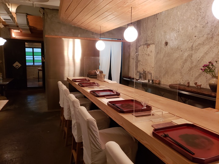 The décor of Godenya embraces a raw, unfinished look, with exposed walls and visible fire hoses, feeling almost like dining in a cave.